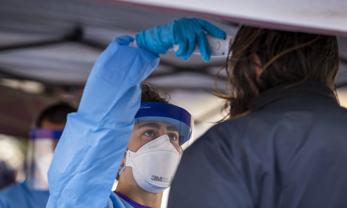 Touro University Nevada medical student Allison Moran, left, screens another homeless man enter ...