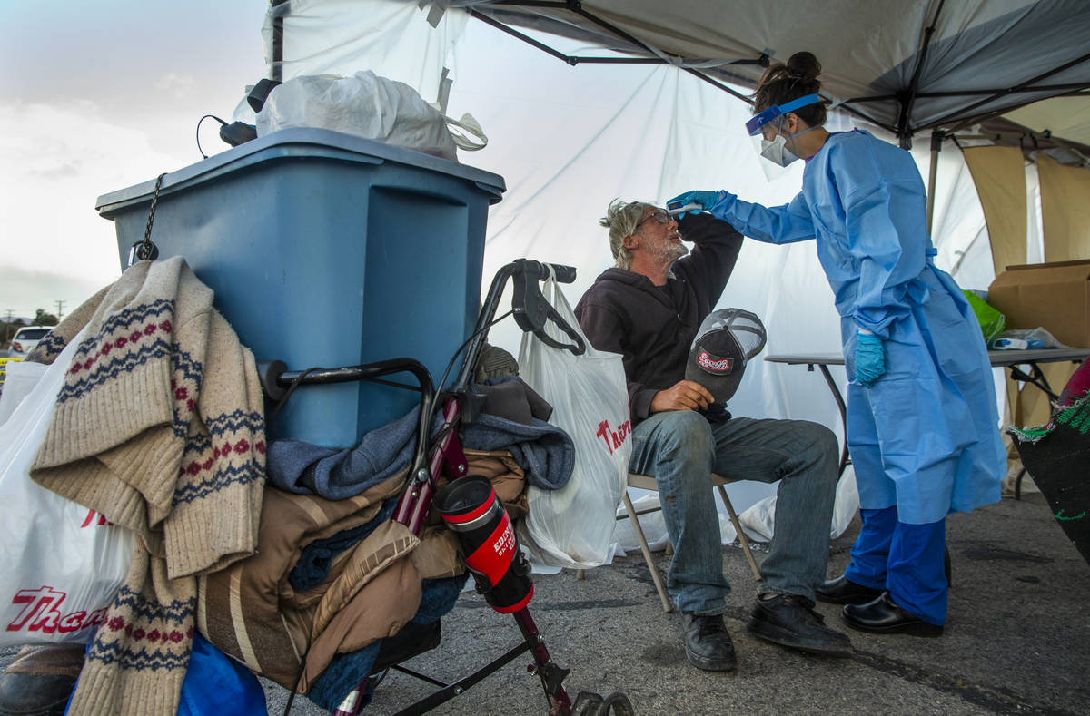 Touro University Nevada medical student Allison Moran, right, screens homeless man Gregory Hemm ...