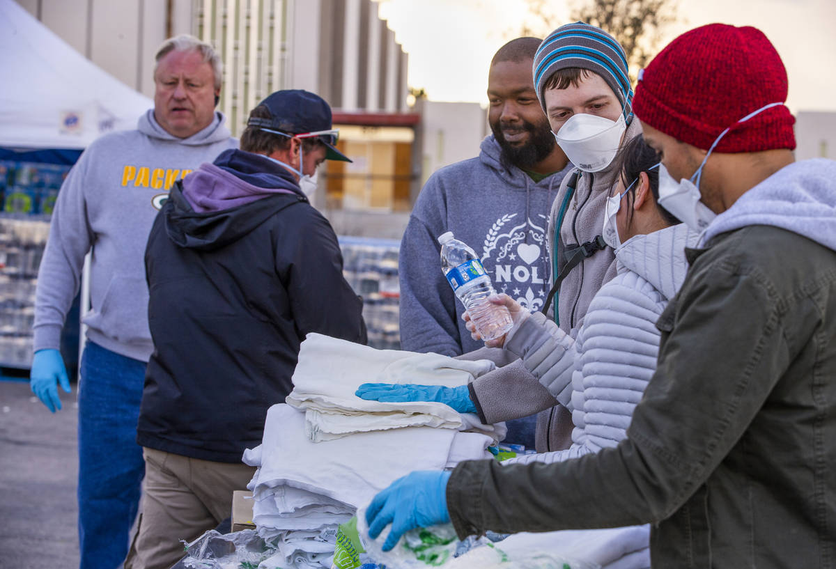 Homeless people who enter receive sheets and water at the temporary shelter in the upper parkin ...