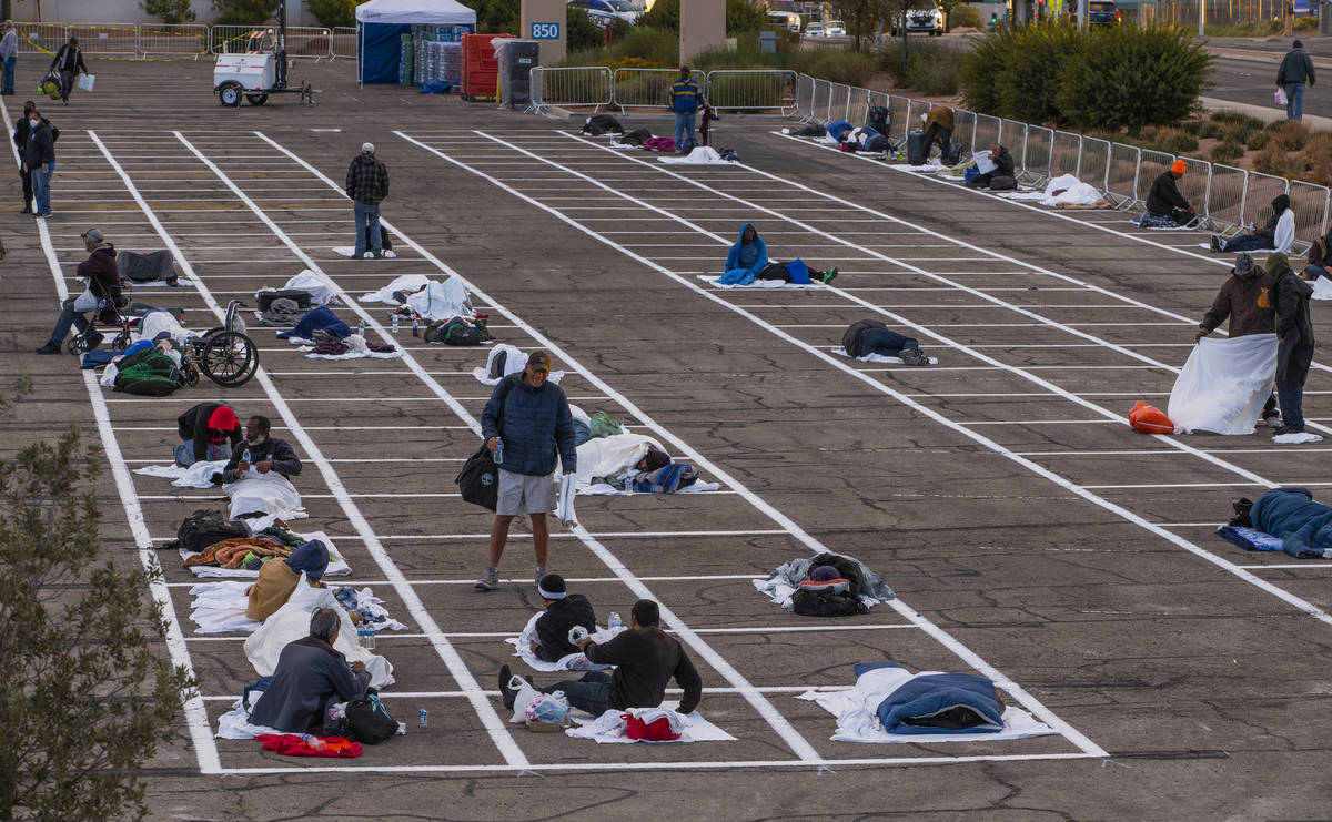 Homeless men settle in for the night with social distancing at the temporary shelter in the upp ...