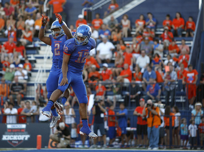 Quarterback Jarrett Solomon, right, of Bishop Gorman High School celebrates with teammate Ta ...