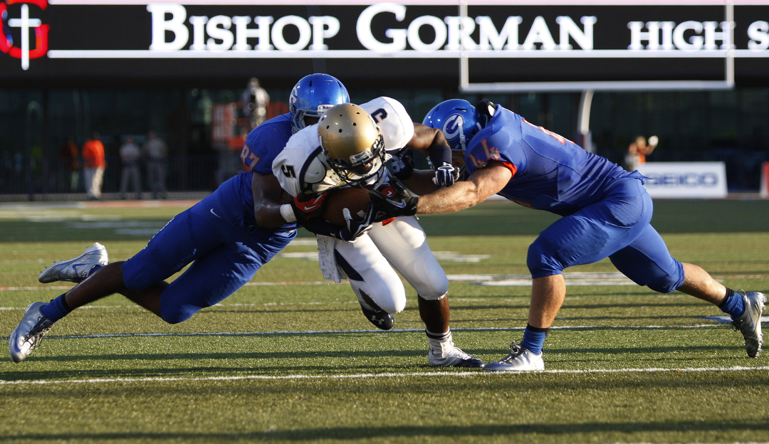 Robert Stanley, left, and Nikolas Stonestreet, right, of Bishop Gorman High School tackle Ke ...