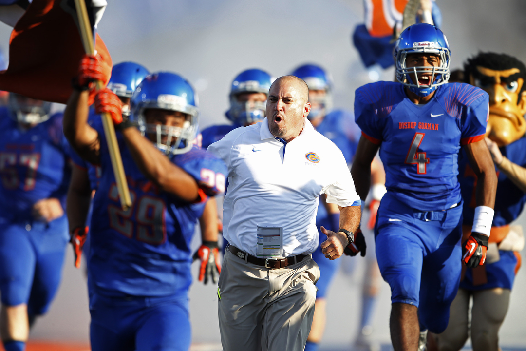 Bishop Gorman High School head coach Tony Sanchez runs on to the field before playing Our La ...