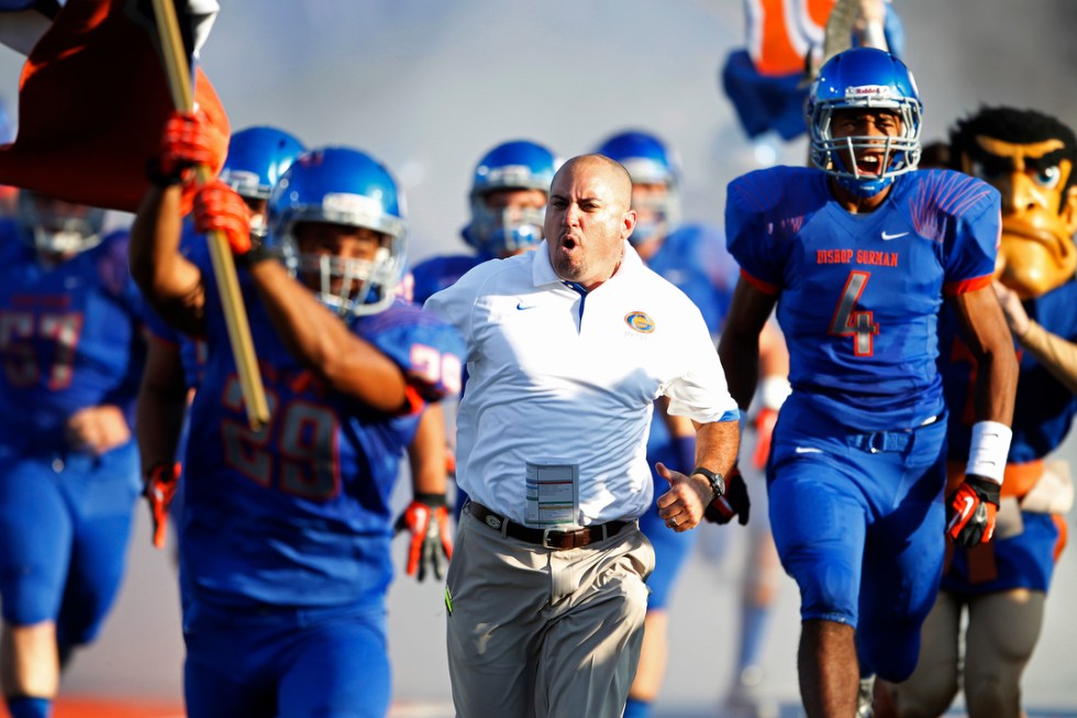 Bishop Gorman High School head coach Tony Sanchez runs on to the field before playing Our La ...