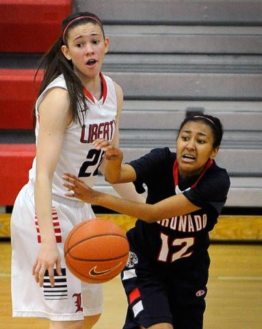 Coronado’s Grace Green (12) passes the ball around Liberty’s Kealy Brown on Tues ...