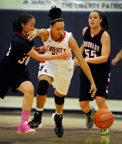 Liberty’s Aubre Fortner, center, brings the ball down court against Coronado’s D ...