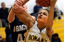 Bonanza’s Sianna Nelson (4) grabs a rebound over Desert Oasis’ Mackenzie Wilcyns ...