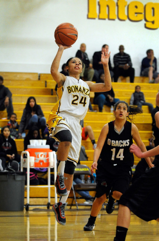 Bonanza’s Jasmine Brass (24) shoots over Desert Oasis’ Brianna Battisti (14) on ...