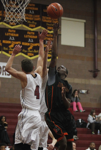 Mojave’s Melvin Irvey (1) shoots over Faith Lutheran’s Blake Bell (4) on Thursda ...