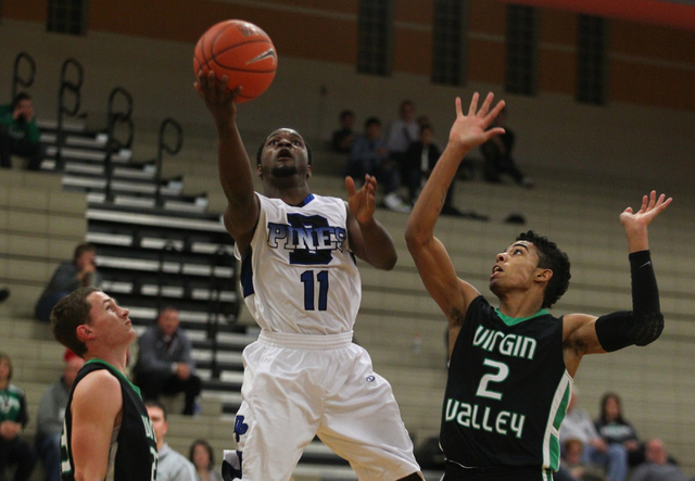 Desert Pines’ Malik Davis (11) shoots over Virgin Valley’s DeVonte Milligan (2) ...