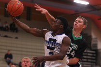 Desert Pines’ Tim Hough (2) drives past Virgin Valley’s Cody Burnside (34) on Fr ...