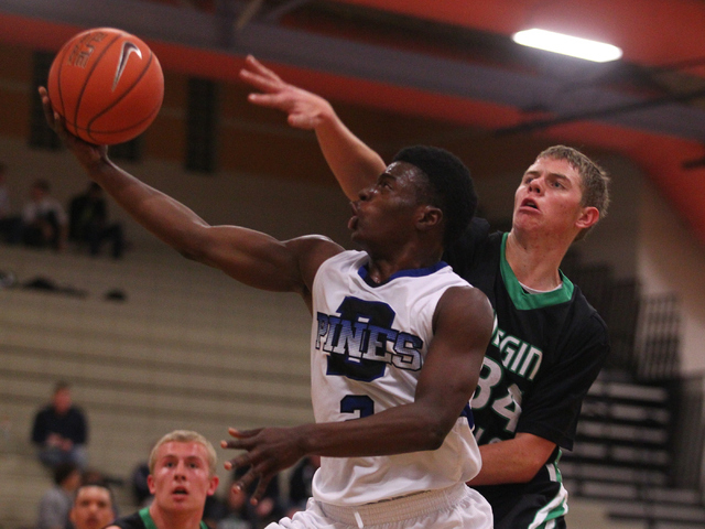 Desert Pines’ Tim Hough (2) drives past Virgin Valley’s Cody Burnside (34) on Fr ...