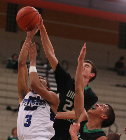 Desert Pines’ Kevin Butler (3) is fouled by Virgin Valley’s Nathan Hughes (22)on ...