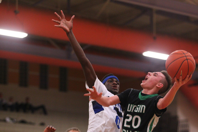 Virgin Valley’s Garrett Leavitt (20) shoots over Desert Pines’ Re’meake Ke ...