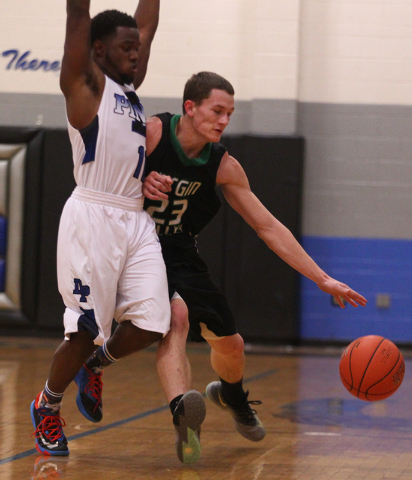 Virgin Valley’s Dee Bowler (23) drives against Desert Pines’ Malik Davis (11) on ...