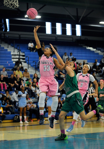 Canyon Springs’ LaKiya Yarber shoots as Green Valley’s Cassandra Palor defends o ...