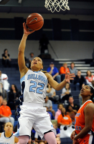 Centennial’s Teirra Hicks (22) goes in for a layup as Bishop Gorman’s Skylar Jac ...