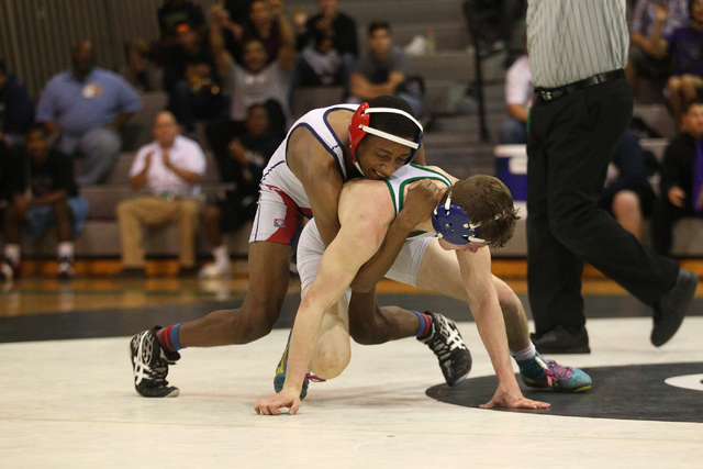 Liberty’s Jaylon Bates maintains a hold on Green Valley’s Josh Temple during the ...