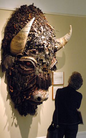FILE - This Jan. 27, 2006 file photo shows a woman looking at Buffalo, a mixed media piece by artist Holly Hughes, part of the Capitol Art Collection at the Capitol in Santa Fe, N.M. The collectio ...