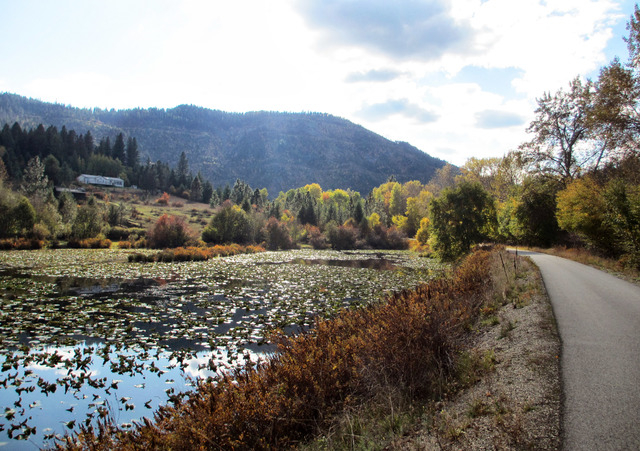 This Oct. 14, 2013 photo shows the path of Trail of the Coeur d'Alenes as it weaves around a small lake and hillside in Idaho. The trail is one of two dozen routes  named to the Rails-to-Trails Co ...