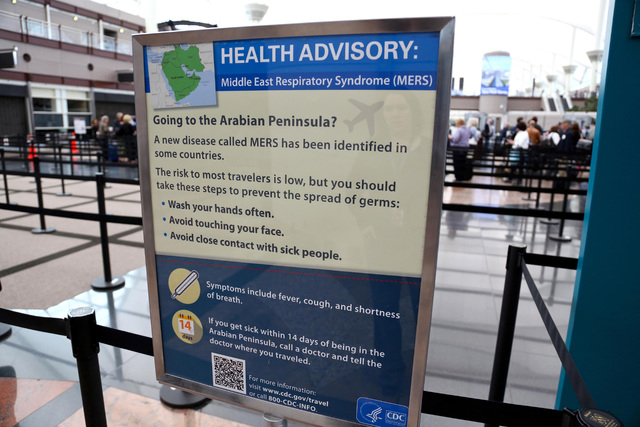 This May 14, 2014 image, provided by Denver International Airport, shows newly-erected signs warning travelers about he danger of the MERS virus, at Denver International Airport. MERS, or Middle E ...