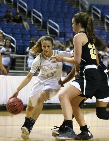 Spring Valley‘s Essence Booker drives past Faith Lutheran‘s Emily Kirvin during ...