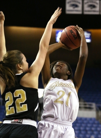 Spring Valley‘s Alana Walker shoots over Faith Lutheran‘s Emily Kirvin during th ...