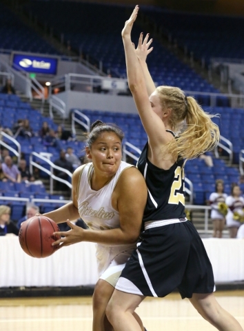 Spring Valley‘s Myra Tadytin looks to pass around Faith Lutheran defender Bryanna Neag ...