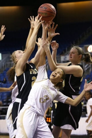 Spring Valley‘s Essence Booker, center battles for a loose ball against Faith Lutheran ...