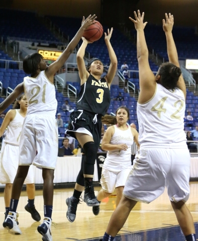 Faith Lutheran‘s Madison Bocobo shoots through a crowd of Spring Valley defenders duri ...