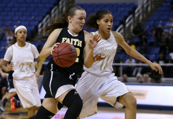 Faith Lutheran‘s Ellery Wilson drives past Spring Valley‘s Kayla Harris during t ...