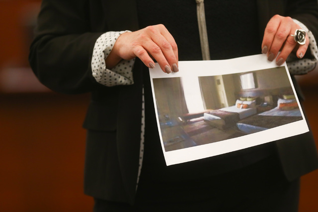 Prosecutor Stacy Kollins shows a photo of a room at the Aliante hotel-casino that Jason Lofthouse sent to a student during his trial at the Regional Justice Center in Las Vegas on Wednesday, March ...