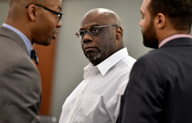 Billy Ray James, center, looks to his attorney, Jonathan MacArthur, left, and assistant Clarence Patterson as he waits for the verdict during his trial at the Regional Justice Center Tuesday, Apri ...