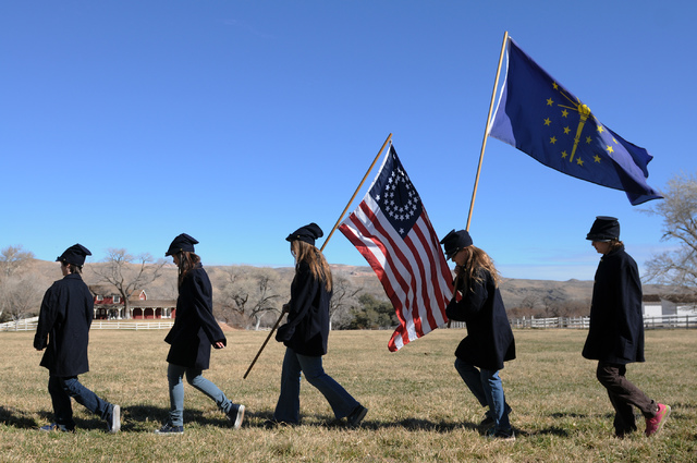 Participants in an educational Civil War re-enactment march to the battlefield carrying flags at Spring Mountain Ranch State Park. (Erik Verduzco/Las Vegas Review-Journal)