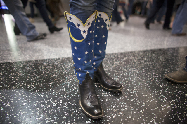 Beth Mathis shows off her cowboy boots at the National Finals Rodeo at Thomas & Mack Center ...