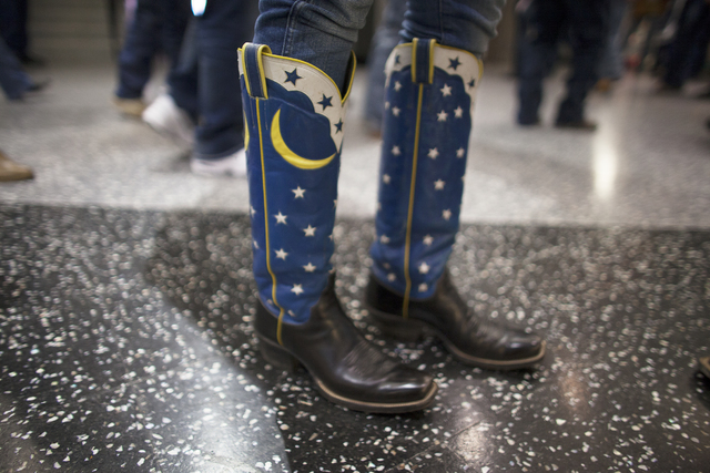 Beth Mathis shows off her cowboy boots at the National Finals Rodeo at Thomas & Mack Center ...