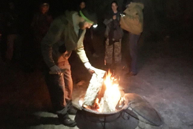Ranger Randy Denter tends to a fire during the night walk on New Year's Eve (and early New Year ...