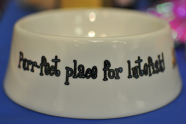 Lutefisk-themed pet-food bowls were among the many mementos sold at the dinner. BRIAN SANDFORD/ ...
