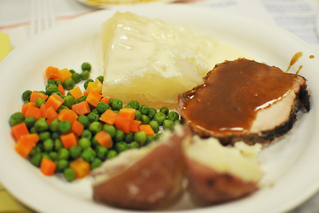 Lutefisk, at the rear of the plate, was served with roasted pork, boiled potatoes and peas and ...