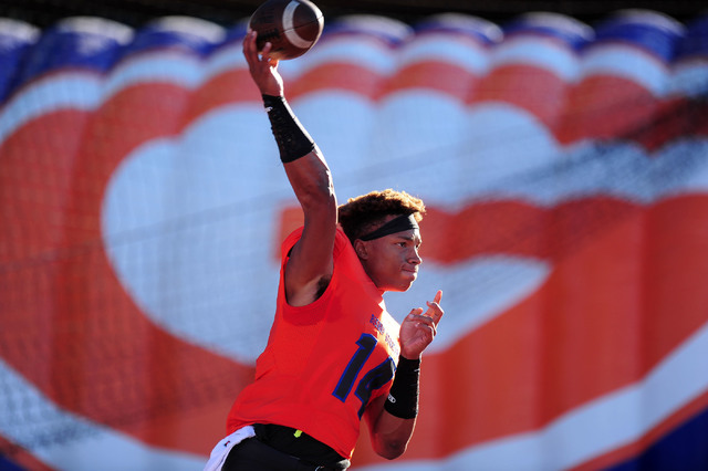 Bishop Gorman quarterback Dorian Thompson-Robinson warms up before the start of their prep f ...