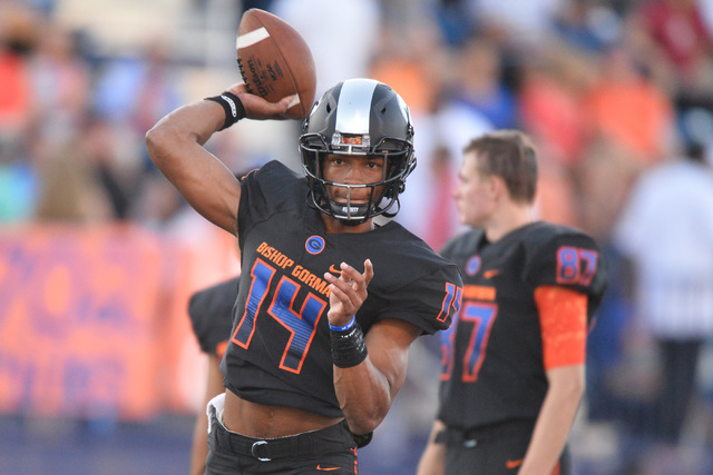 Bishop Gorman quarterback Dorian Thompson-Robinson (14) warms up before the Bishop Gorman Hi ...