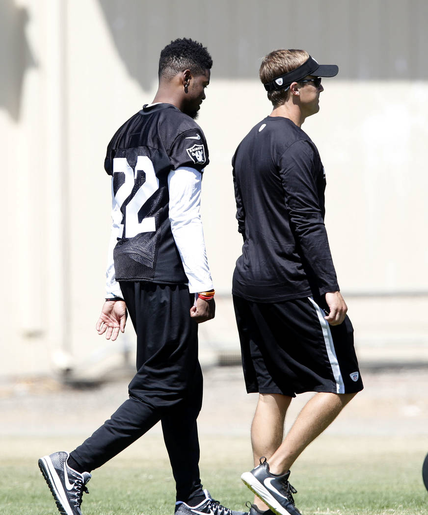 The Oakland Raiders cornerback Gareon Conley (22) walks on the sideline with quarterbacks coach Jake Peetz during teams practice at Raiders Napa Valley training complex in Napa, Calif., on Monday, ...