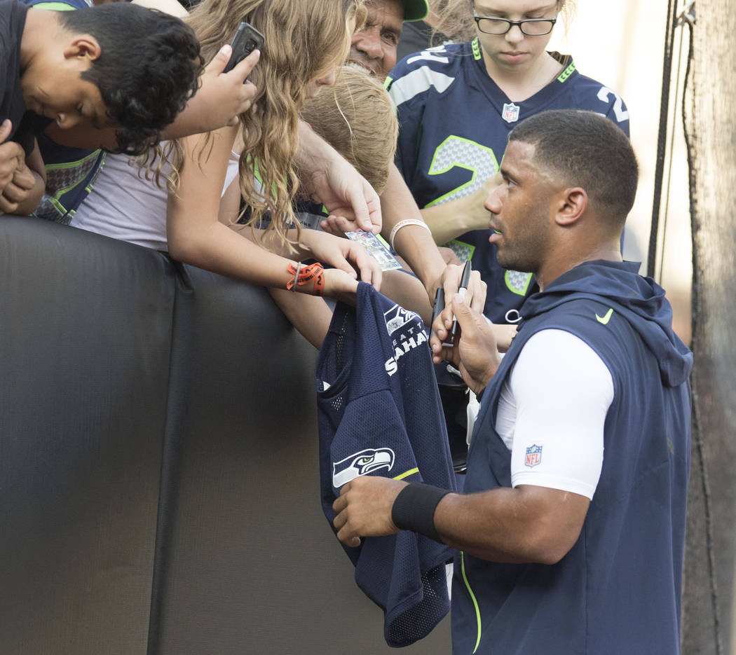 Seattle Seahawks quarterback Russell Wilson (3) signs autographs prior to a preseason game against the Oakland Raiders in Oakland, Calif., Thursday, Aug. 31, 2017. Heidi Fang Las Vegas Review-Jour ...