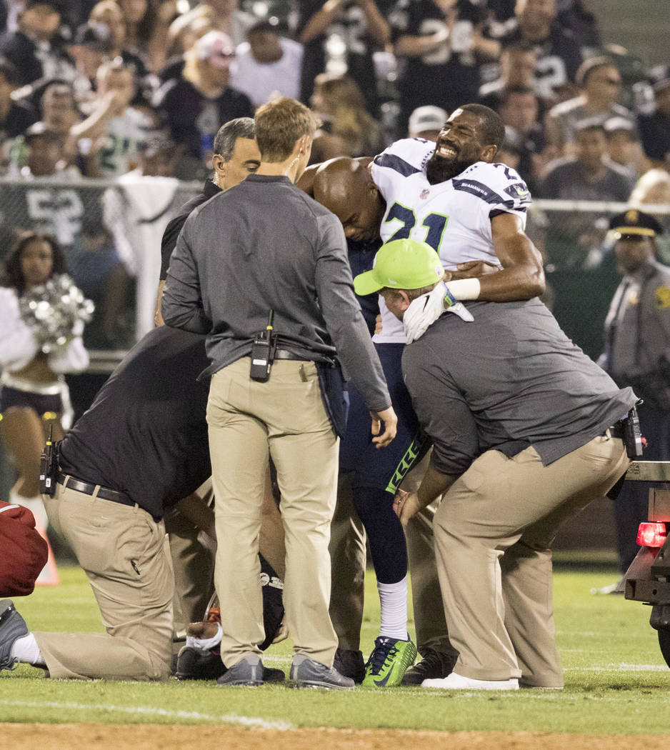 Injured Seattle Seahawks cornerback DeAndre Elliott (21) is lifted onto a cart in the first half of the preseason game in Oakland, Calif., Thursday, Aug. 31, 2017. Heidi Fang Las Vegas Review-Jour ...