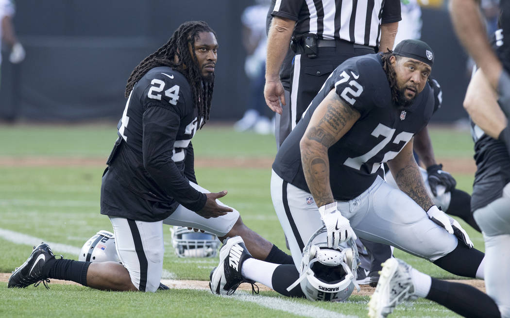 Oakland Raiders running back Marshawn Lynch (24) and tackle Donald Penn (72) warm up prior to the preseason game against Seattle Seahawks in Oakland, Calif., Thursday, Aug. 31, 2017. Heidi Fang La ...