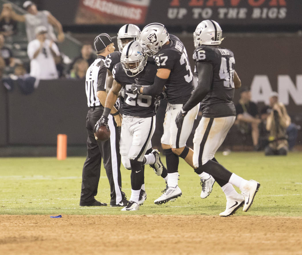 Oakland Raiders safety Shalom Luani (26) celebrates his interception against the Seattle Seahawks in the first half of their preseason game in Oakland, Calif., Thursday, Aug. 31, 2017. Heidi Fang  ...