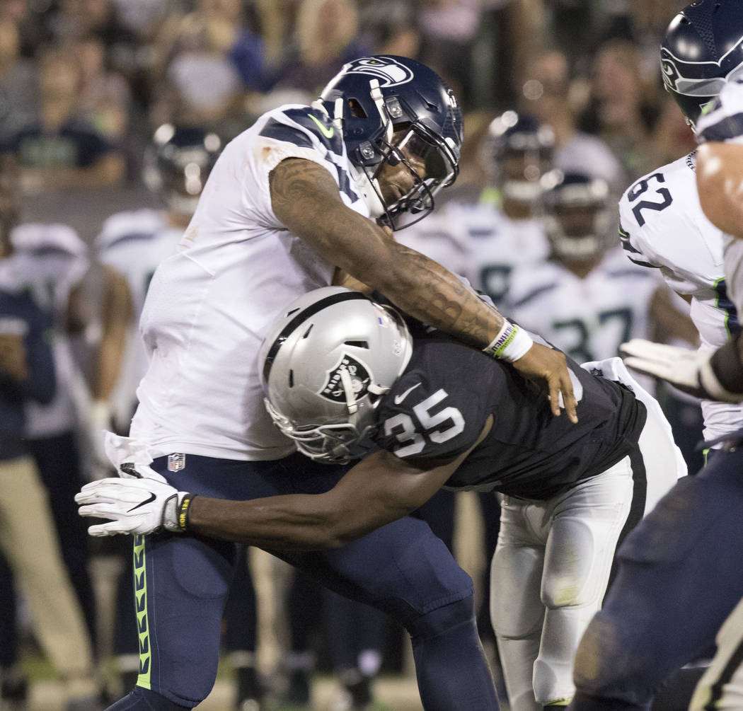 Seattle Seahawks quarterback Trevone Boykin (2) gets tackled by Oakland Raiders linebacker Nicholas Morrow (35) in the first half of the preseason game in Oakland, Calif., Thursday, Aug. 31, 2017. ...