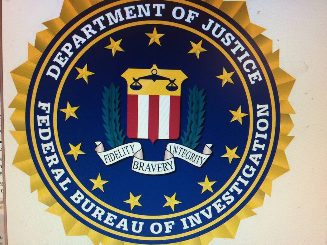 The insignia for the Federal Bureau of Investigation is seen on a computer screen. Scammers will sometimes use official symbols on their phishing emails then tell them that the FBI is after them.  ...