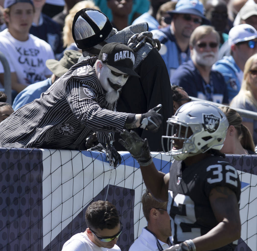 Oakland Raiders defensive back Antonio Hamilton (32) high fives a fan after the team scored in the first quarter against the Tennessee Titans at the Nissan Stadium in Nashville, Tenn., Sunday, Sep ...