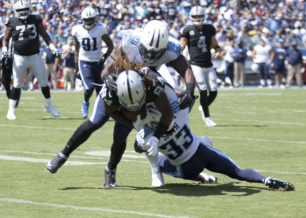 Oakland Raiders wide receiver Cordarrelle Patterson (84) is tackled by defenders in the first half of the NFL game against the Tennessee Titans at the Nissan Stadium in Nashville, Tenn., Sunday, S ...